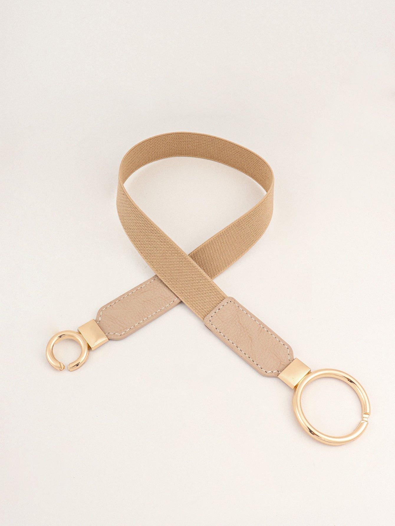Tan elastic belt with faux leather ends and gold interlocked ring buckle