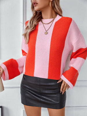 Colorblock stripe knit sweater in pink and orange with bell sleeves.