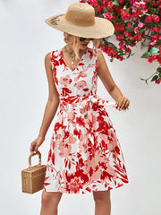 Watercolor floral tiered mini dress with V-neck, belted waist, and red/pink blooms.