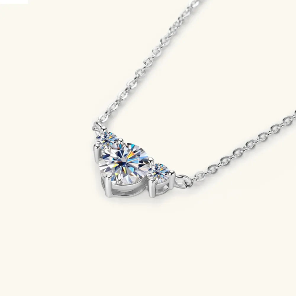 Silver necklace with three sparkling diamonds in a graduated design.