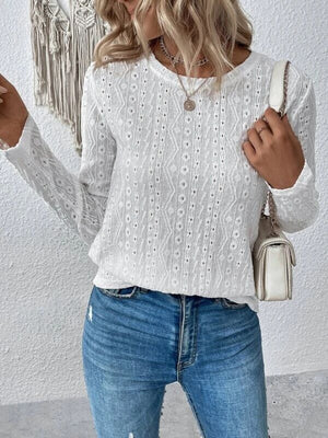 White geometric eyelet long sleeve knit top with crew neck.