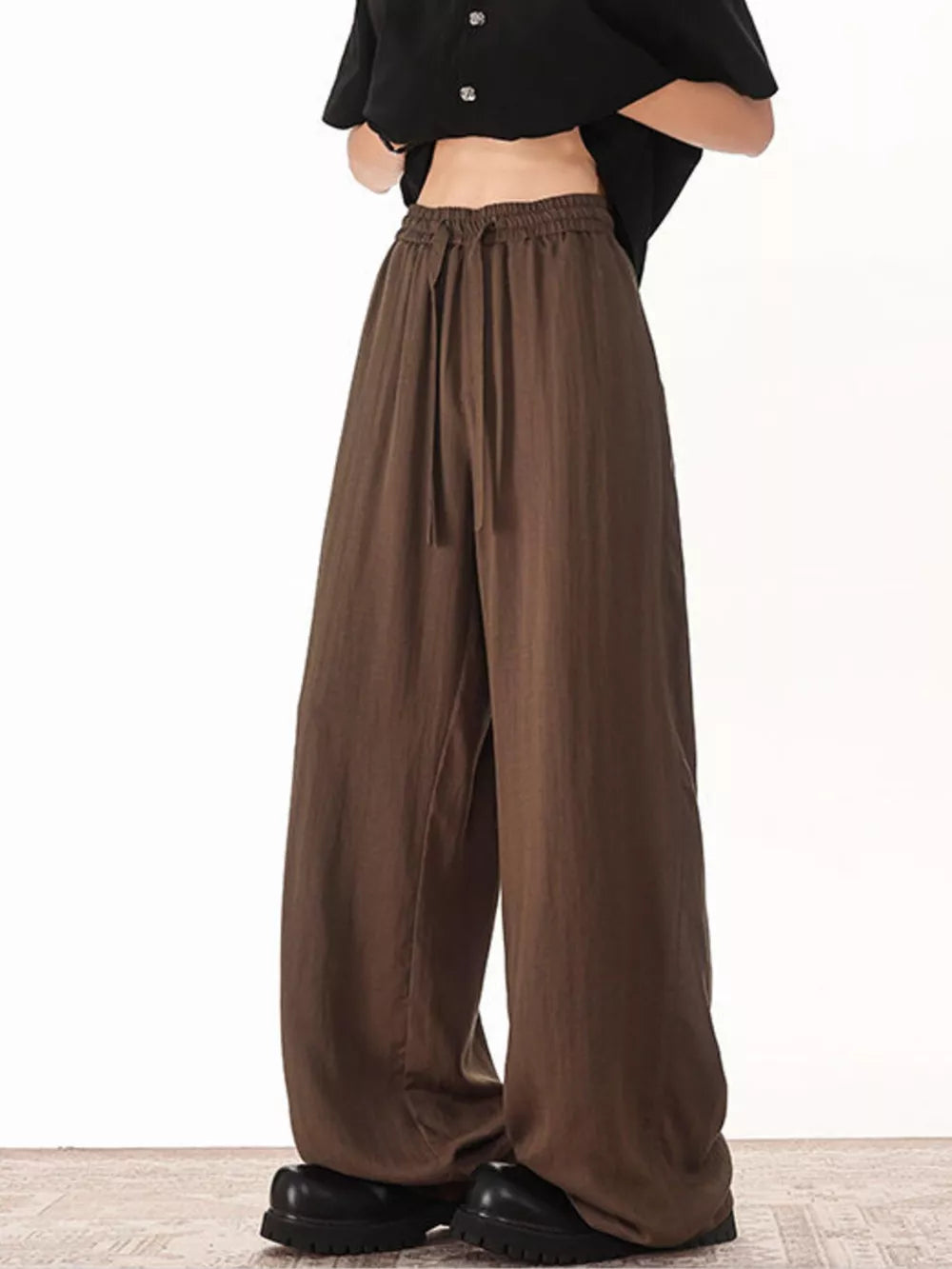 Brown drawstring sweatpants with a relaxed fit and wide leg.
