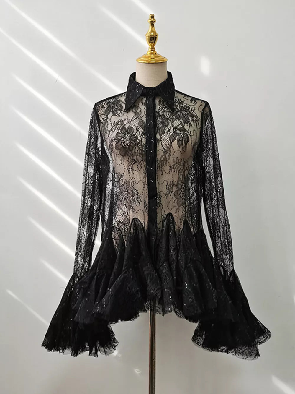 Black lace floral dress with ruffle hem and bell sleeves.