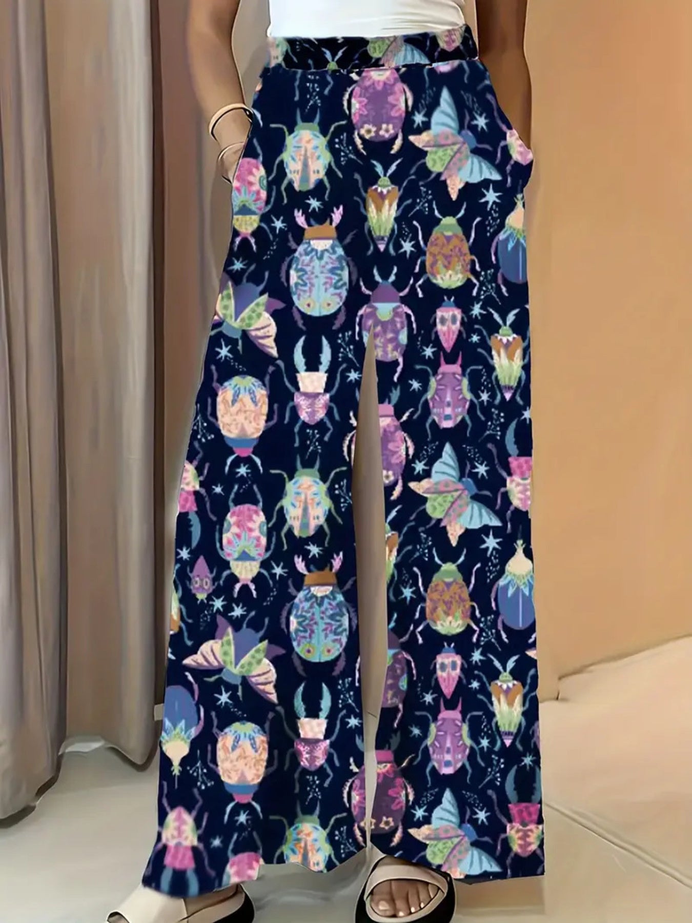 Dark blue wide-leg maternity trousers with a colorful beetle and butterfly print.