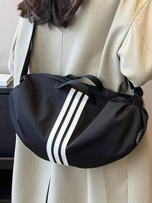 Black Oxford cloth crossbody bag with white stripes and adjustable strap.