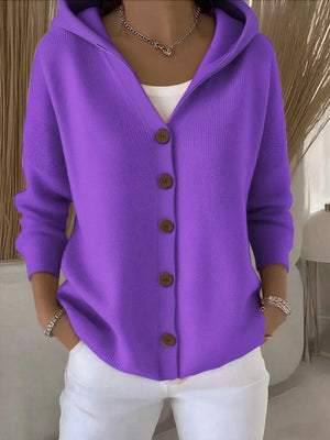Purple hooded button-front knit cardigan with wooden buttons, worn over a white top.