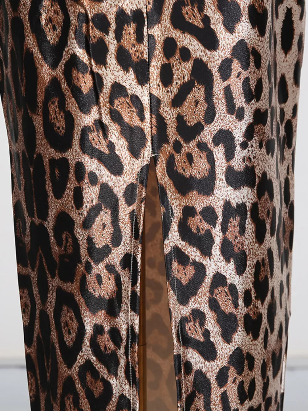 Chic leopard print bodycon midi dress with a thigh-high slit detail.