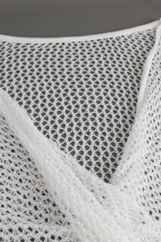 White crochet blouse with open knit detail and pearl chain strap.