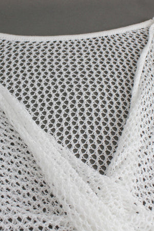 White crochet blouse with open knit detail and pearl chain strap.