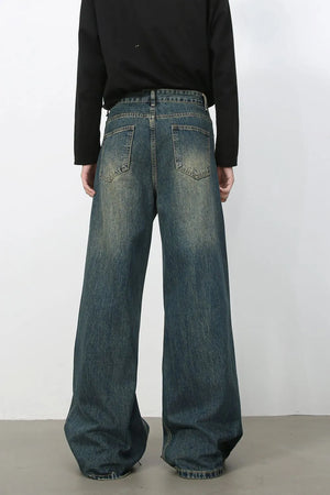Dark wash wide-leg denim jeans with distressed details and a relaxed fit.