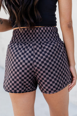 Elastic waist checkerboard running shorts in plaid with a relaxed fit.