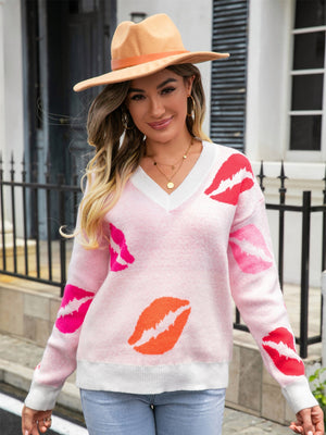 Pink V-neck knit pullover sweater with kiss print and white trim.