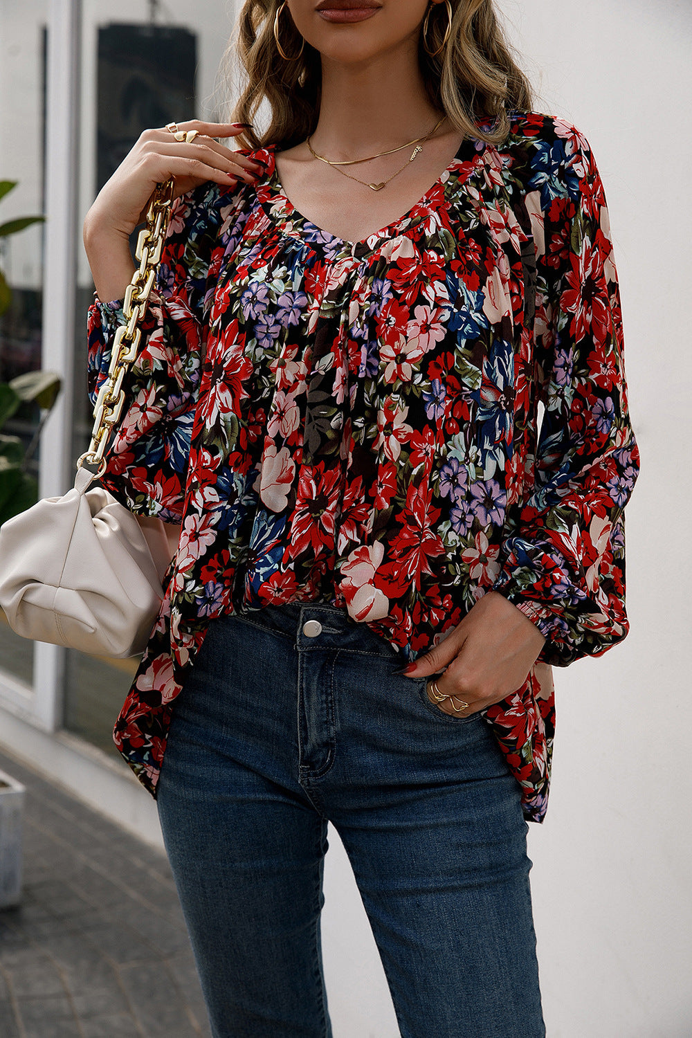 Floral print gathered yoke blouse with balloon sleeves and v-neck.