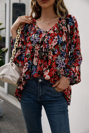 Floral print gathered yoke blouse with balloon sleeves and v-neck.