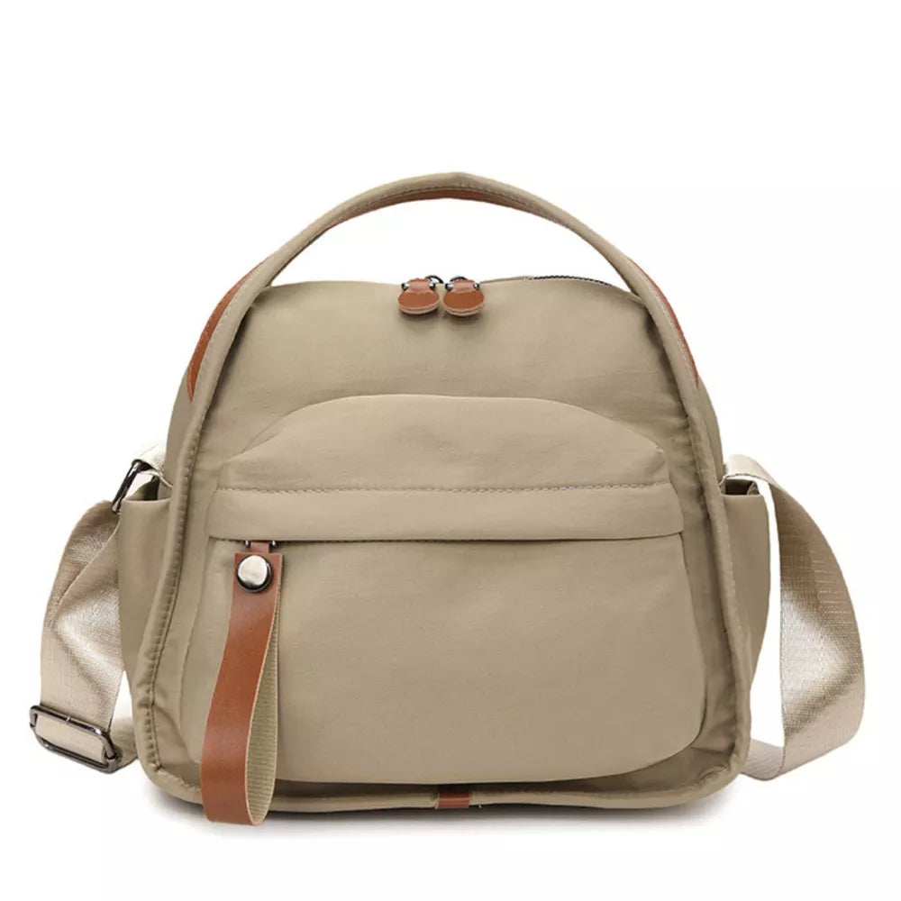 Khaki nylon chest bag with multiple pockets and leather accents.