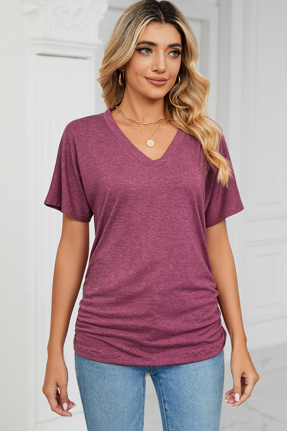 Drape-front V-neck tee in deep purple with side ruching and short dolman sleeves.