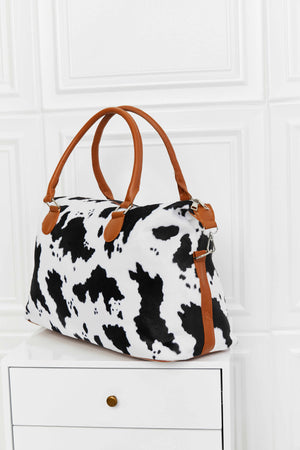 Cow print satchel bag with brown leatherette handles and trim