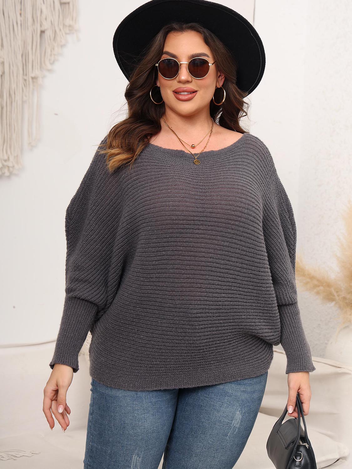 Off-shoulder ribbed knit sweater in charcoal with batwing sleeves.