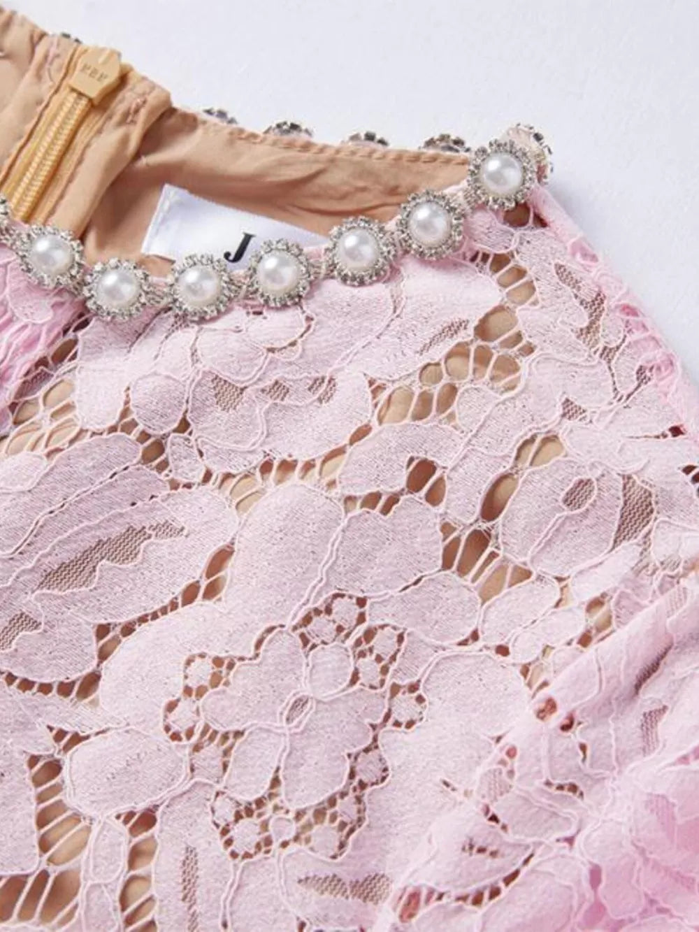 Powder floral lace dress with pearl and crystal embellished neckline.