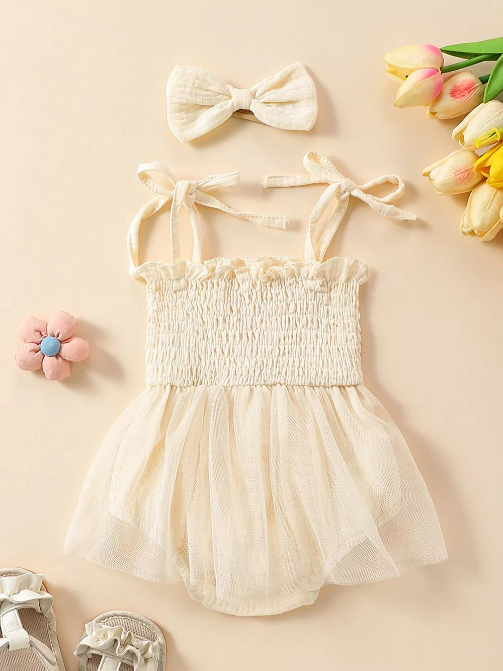 Apricot smocked bodysuit with tulle skirt and matching bow headband.