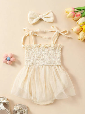 Apricot smocked bodysuit with tulle skirt and matching bow headband.