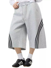 Gray cropped sweatpants with wide legs and black side stripes