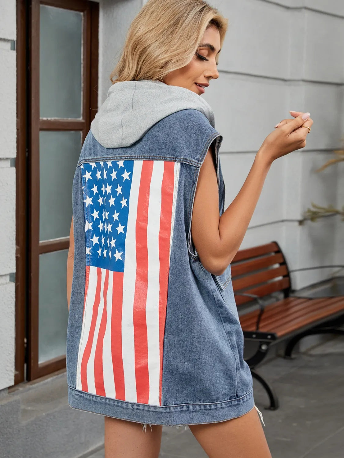 Denim hooded vest with American flag graphic on back, with hat.