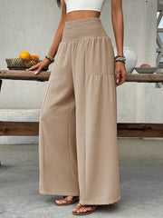 Beige cotton smocked waist wide leg maternity trousers with tiered detail.