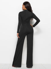 Black high-waisted palazzo jumpsuit with long sleeves and a slit front detail.