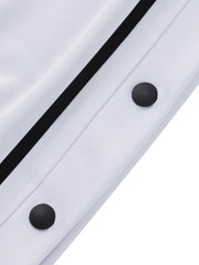 White track pants with black snap buttons and side stripe detail.