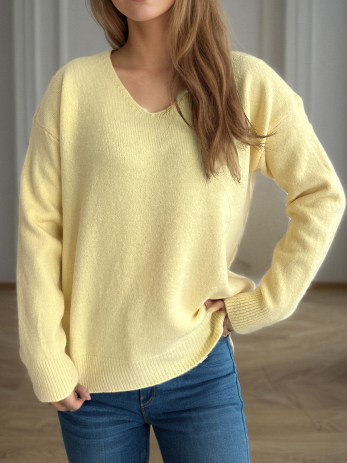 Light Yellow V-neck knit sweater with ribbed hem and cuffs.