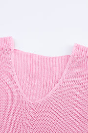 Relaxed knit v-neck pullover in blush pink acrylic with ribbed texture.