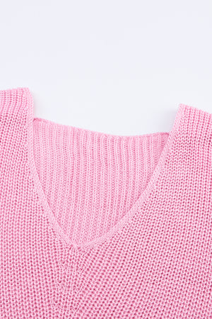 Relaxed knit v-neck pullover in blush pink acrylic with ribbed texture.
