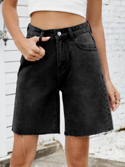 Black longline denim cutoff shorts with a raw hem and a relaxed fit.