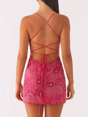 Fuchsia pink mini dress with floral embellishments and a lace-up back.