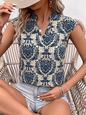 Ornate cap sleeve blouse with notch neckline in blue and cream damask print.