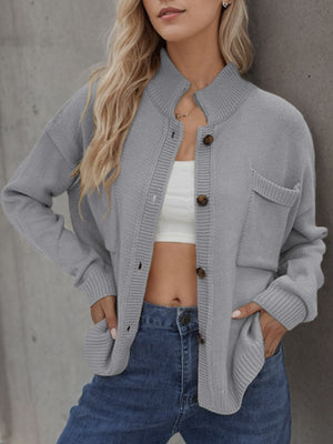 Gray acrylic knit cardigan with stand collar, button front, and chest pockets.