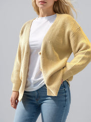 Pastel yellow ribbed knit cardigan with balloon sleeves and button front.