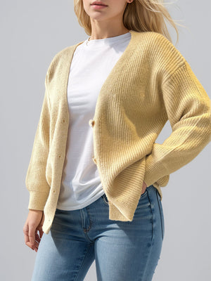 Pastel yellow ribbed knit cardigan with balloon sleeves and button front.