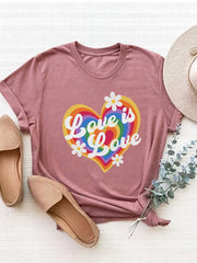 Dusty Pink graphic tee with rainbow heart and "Love is Love" text, short sleeves, crew neck.