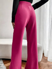 Sleek high-waisted flare maternity pants in cerise, showing the flared leg detail.