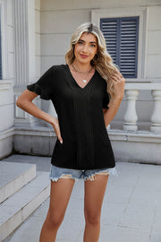 Black textured pleat front v-neck blouse with flutter sleeves.