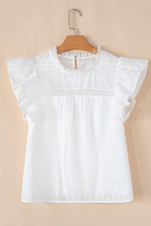 White eyelet yoke blouse with ruffle sleeves and a lace inset detail.