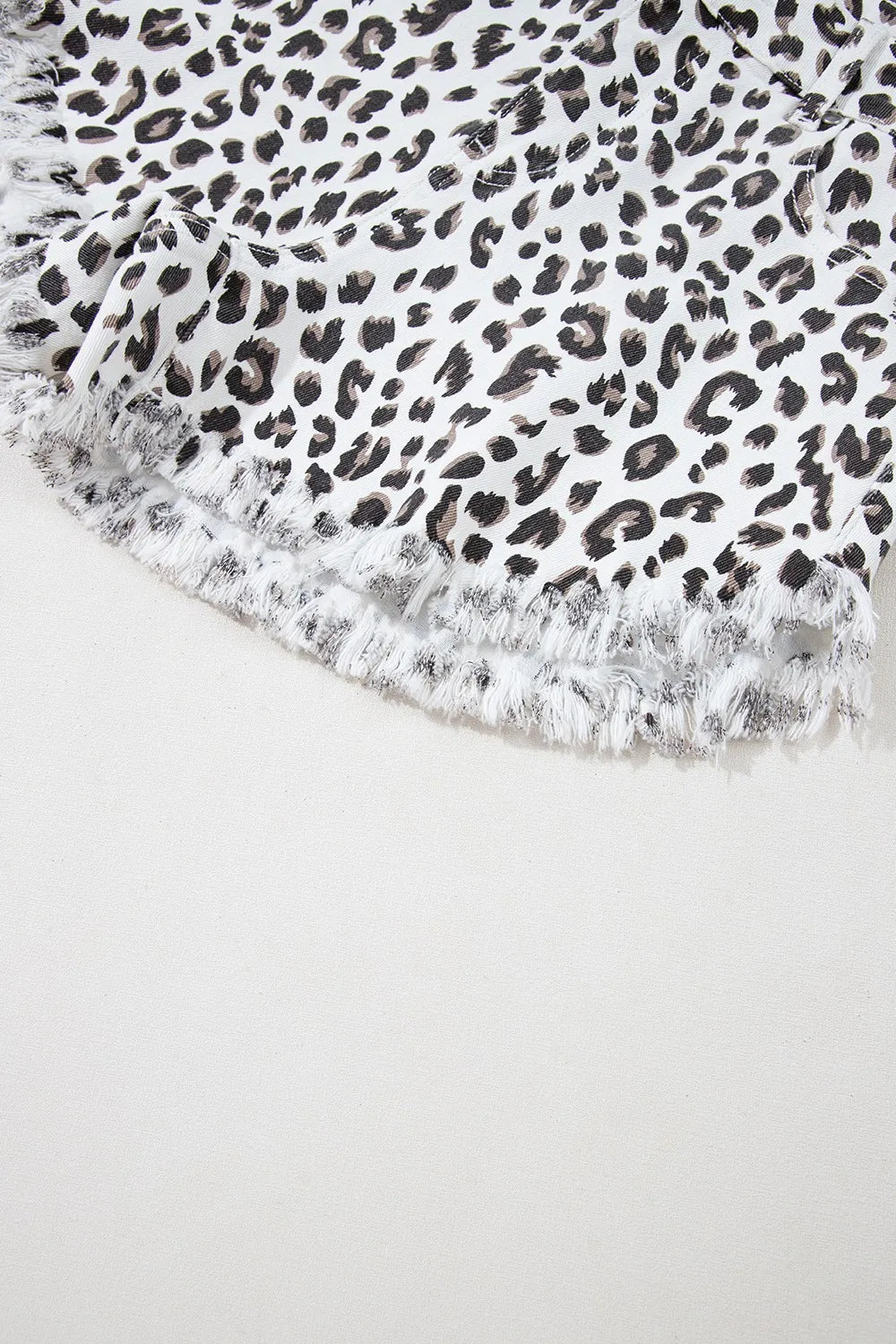Leopard print denim shorts with frayed hem detail