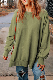 Oversized washed cotton sweatshirt in Sage with crew neck, long sleeves, and side slits.