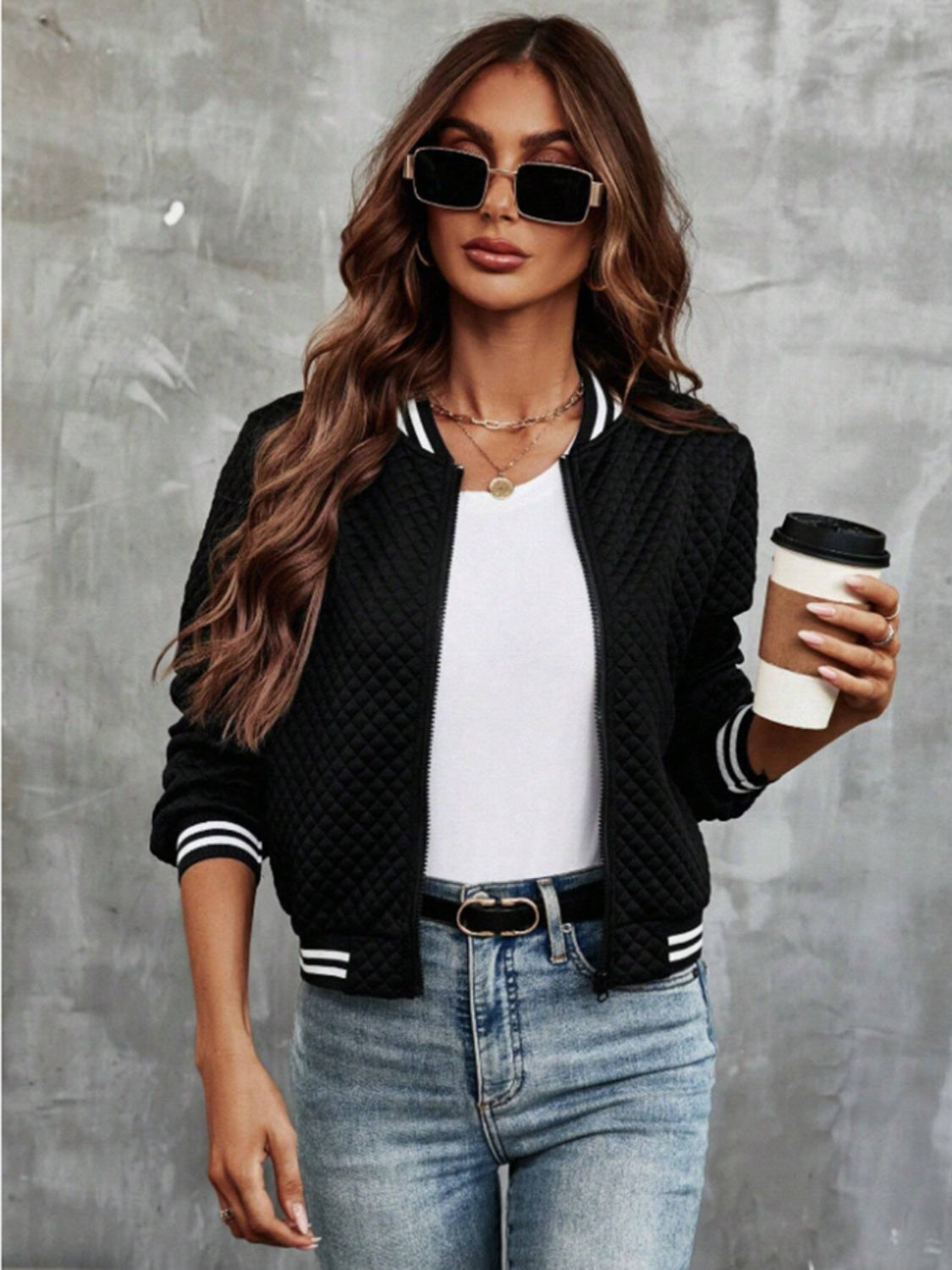 Black quilted bomber jacket with striped ribbing on collar and cuffs.