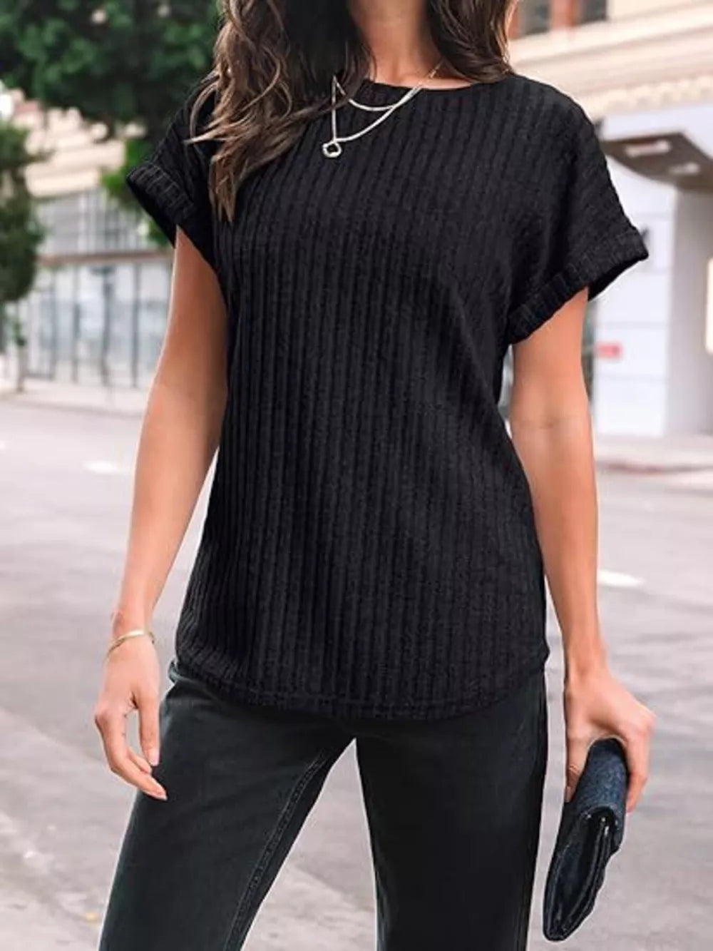Black ribbed knit t-shirt with cuffed short sleeves and a crew neck.
