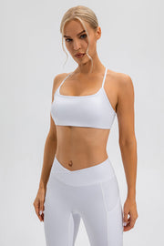 White sports bra with crisscross back straps and a square neckline.