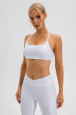 White sports bra with crisscross back straps and a square neckline.