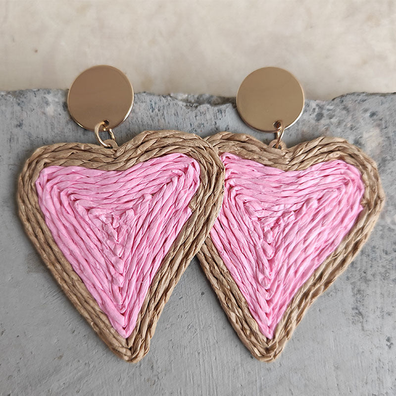 Pink woven heart statement earrings with gold disc tops.